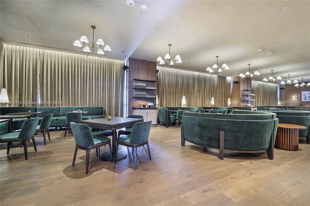 dining area with a chandelier and light wood-style floors
