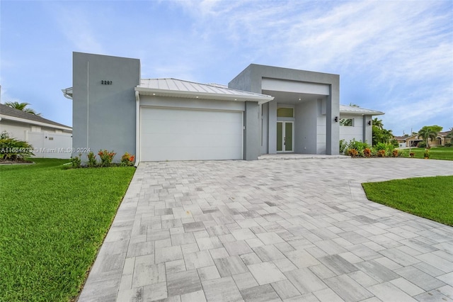 view of front facade with a garage and a front lawn