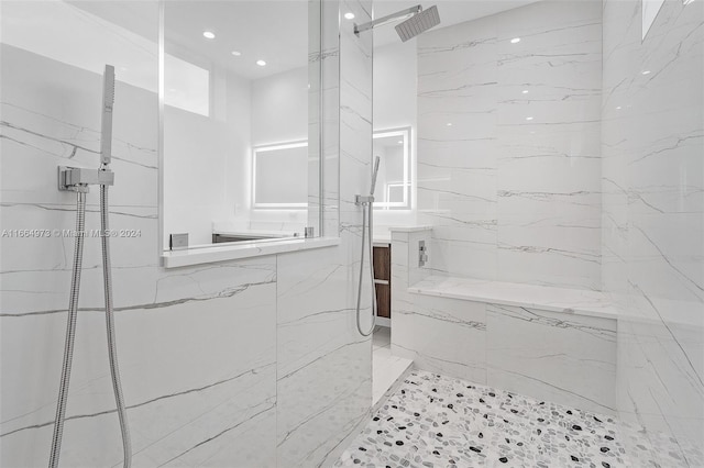 bathroom featuring vanity and tiled shower