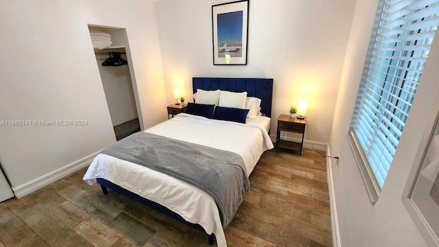 bedroom featuring hardwood / wood-style floors and a closet