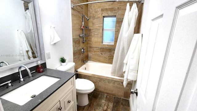 full bathroom featuring wood-type flooring, plenty of natural light, shower / bathtub combination with curtain, vanity, and toilet