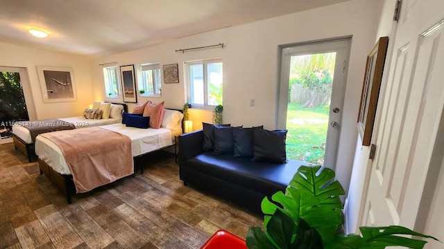 bedroom with access to outside and dark hardwood / wood-style flooring