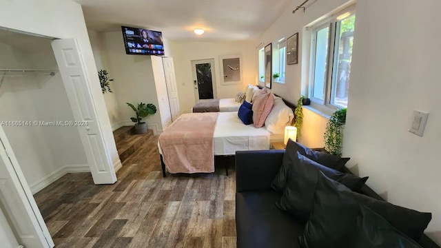 bedroom featuring a closet and dark hardwood / wood-style floors