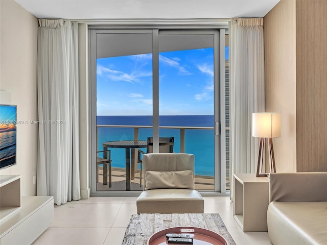 living room with a wall of windows and a water view