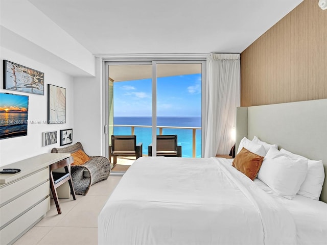 tiled bedroom with a water view and access to exterior