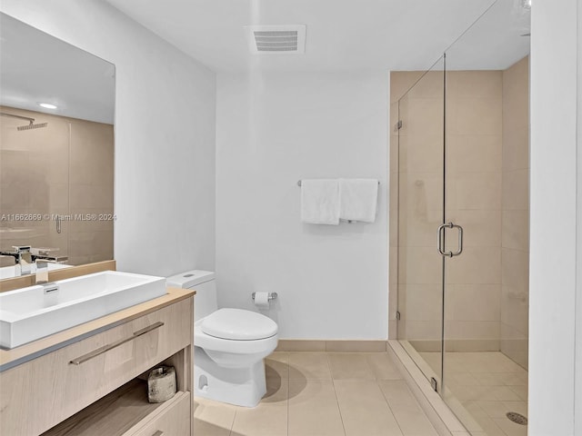 bathroom featuring walk in shower, vanity, toilet, and tile patterned floors