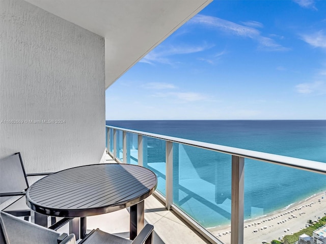 balcony with a beach view and a water view