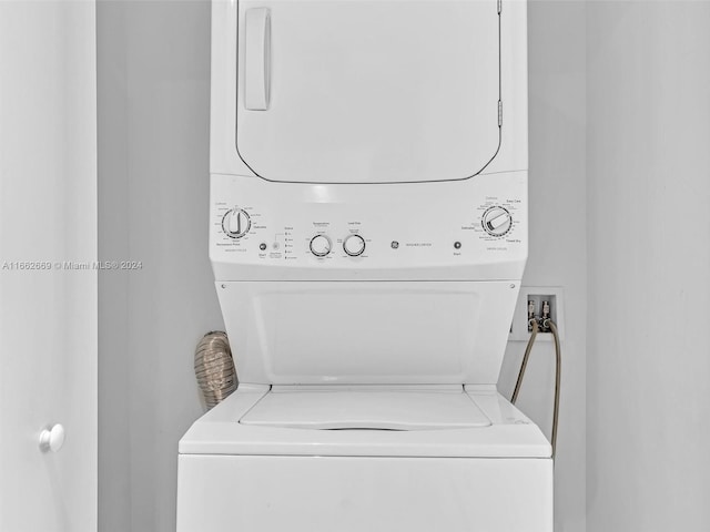 laundry room featuring stacked washer / drying machine