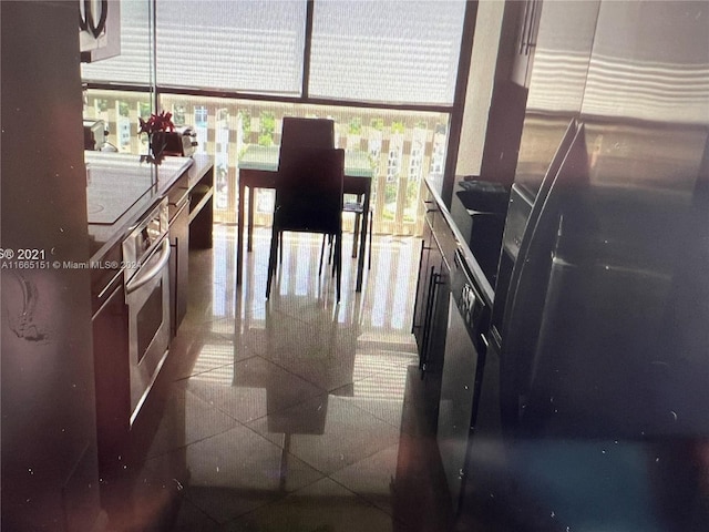 interior space featuring oven and black fridge