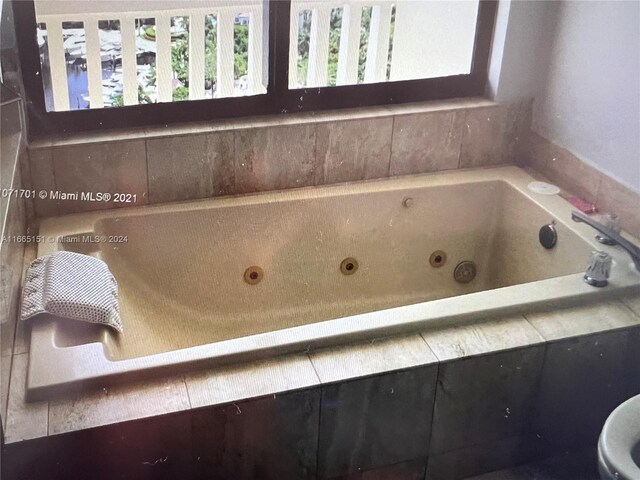 bathroom featuring tiled bath