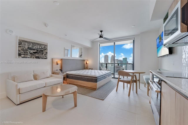 bedroom featuring ceiling fan, access to outside, and expansive windows