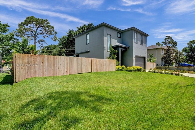 4593 Meadow Green Trl, Lake Worth, FL 33463 - view of property exterior featuring a garage and stucco siding