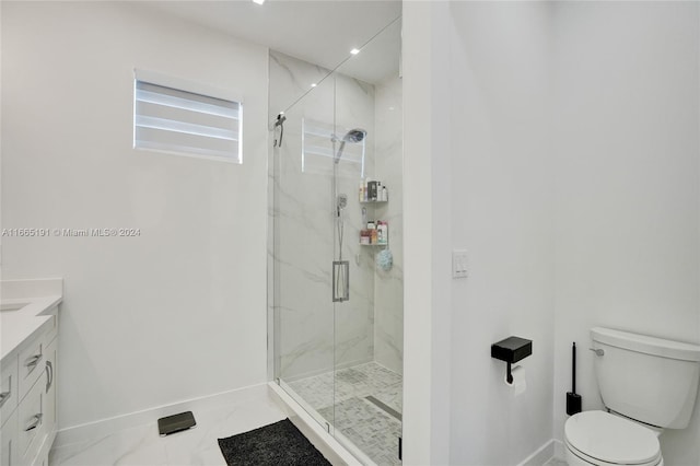 bathroom featuring a shower with door, vanity, and toilet