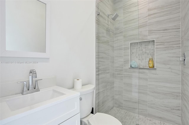 bathroom featuring walk in shower, vanity, and toilet