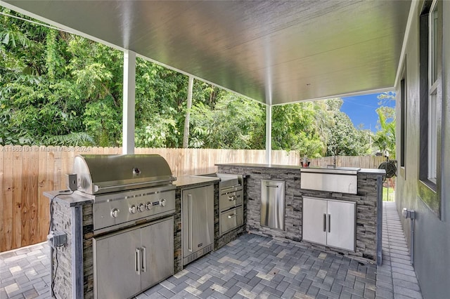 4593 Meadow Green Trl, Lake Worth, FL 33463 - view of patio / terrace with a fenced backyard, exterior kitchen, a grill, and a sink