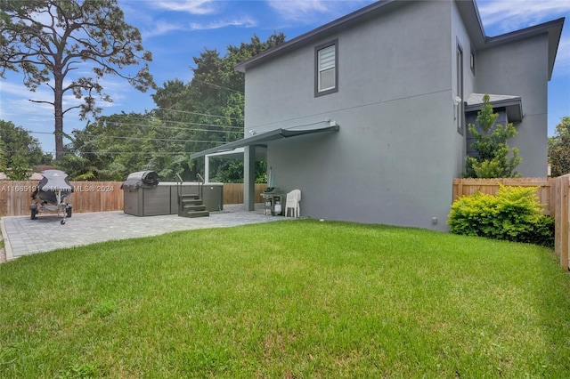 4593 Meadow Green Trl, Lake Worth, FL 33463 - rear view of property featuring a hot tub, a patio, and stucco siding