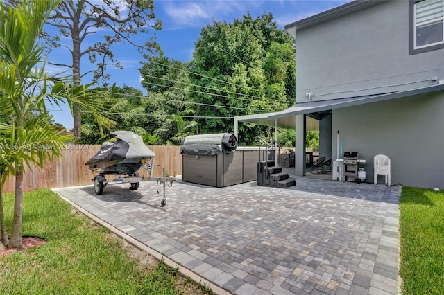 4593 Meadow Green Trl, Lake Worth, FL 33463 - view of patio / terrace featuring a hot tub and a fenced backyard