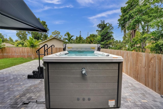 exterior details featuring a hot tub and wood walls