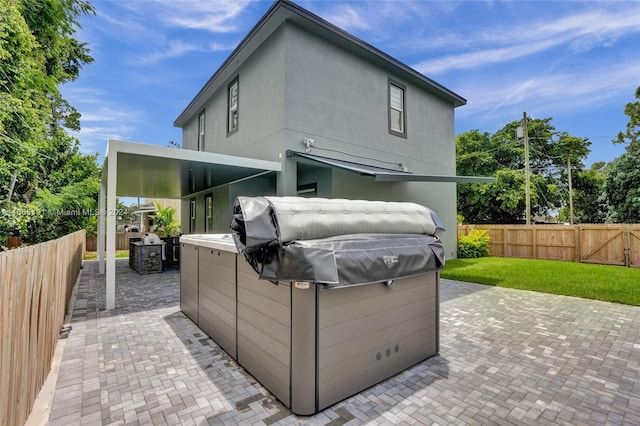 4593 Meadow Green Trl, Lake Worth, FL 33463 - back of house with a fenced backyard, a patio area, and a hot tub