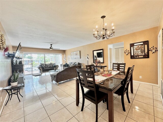 tiled dining room featuring an inviting chandelier