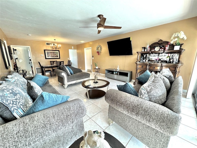 tiled living room with ceiling fan with notable chandelier