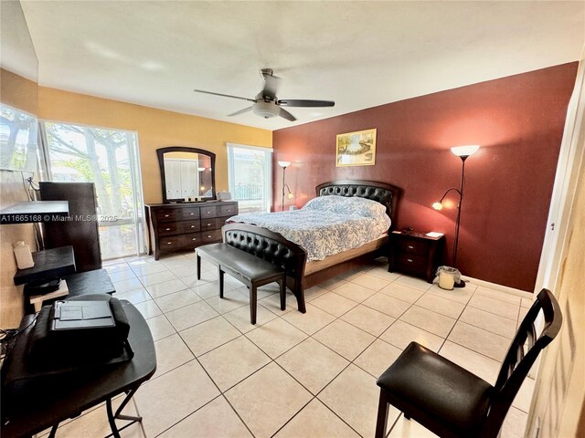 tiled bedroom with ceiling fan and a closet