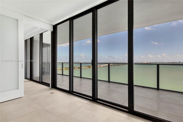 interior space featuring expansive windows and a water view