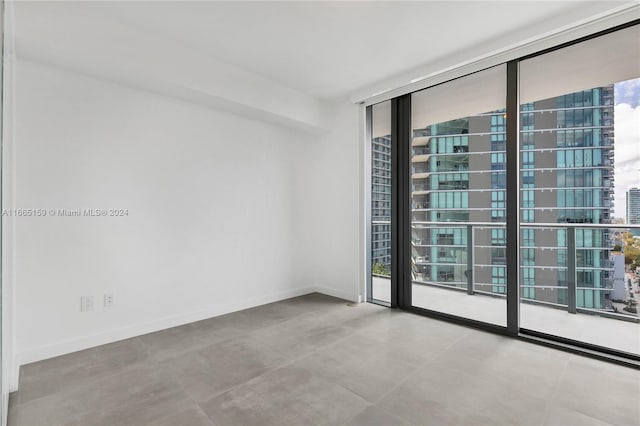 unfurnished room featuring expansive windows