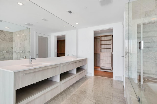 bathroom with tile patterned flooring, a shower with door, and vanity