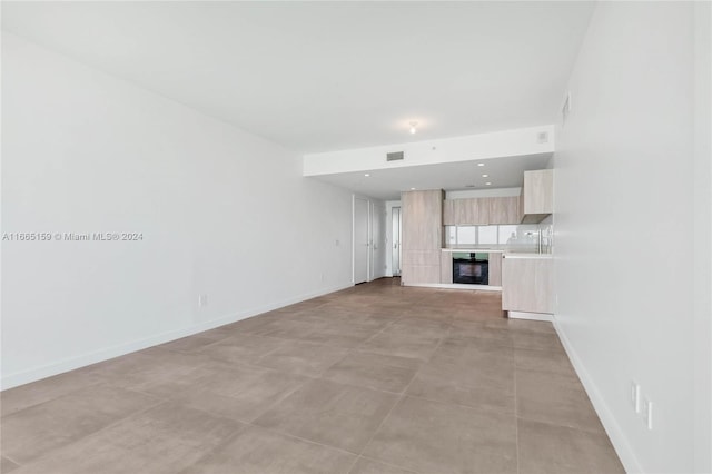 unfurnished living room featuring light tile patterned floors