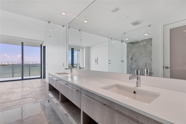 bathroom with tile patterned flooring, a shower with shower door, plenty of natural light, and vanity