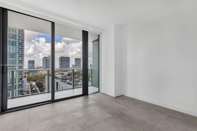 empty room featuring concrete floors and a wall of windows