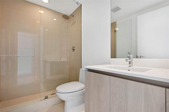 bathroom featuring tile patterned flooring, vanity, toilet, and a shower with door