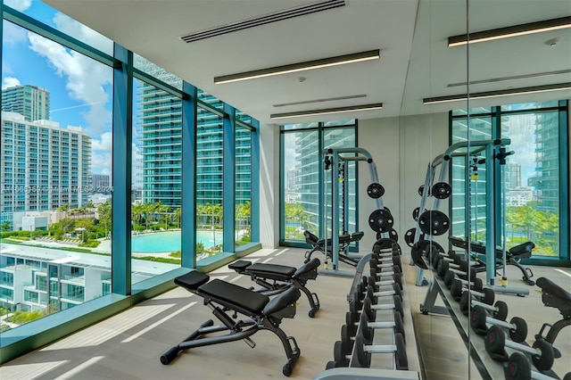 gym with a wall of windows