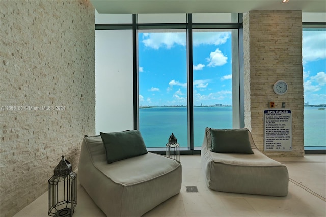 living area featuring a water view and expansive windows