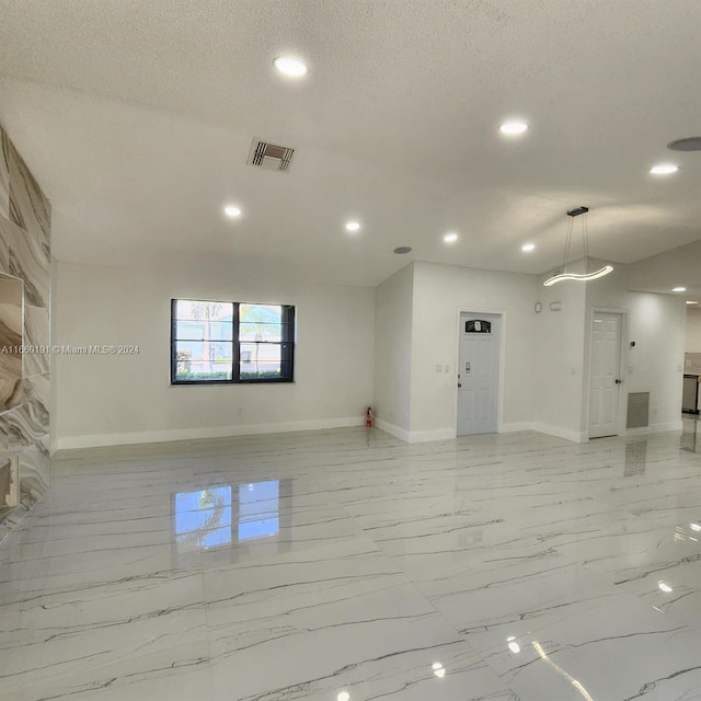 spare room with a textured ceiling