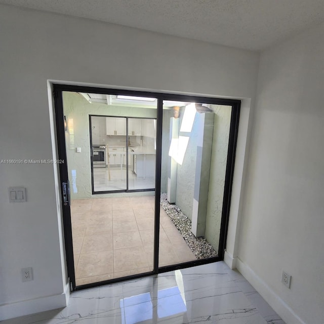 doorway featuring a textured ceiling