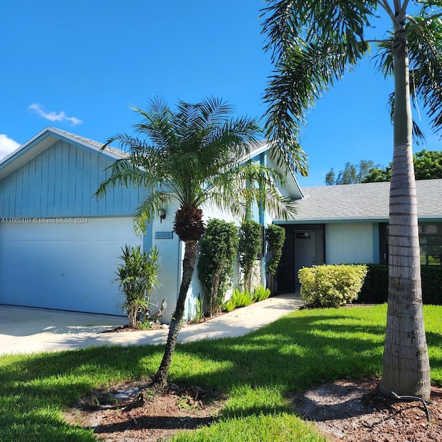 view of front facade with a front lawn and a garage