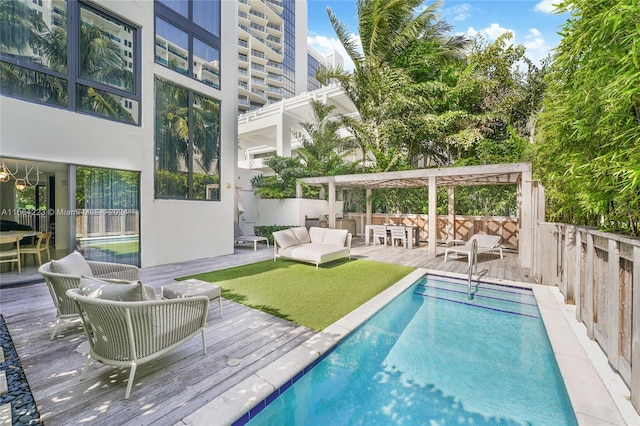 view of pool featuring an outdoor hangout area, a pergola, and a deck