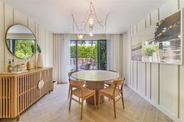 dining area featuring an inviting chandelier and light hardwood / wood-style flooring