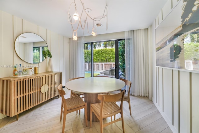 dining room featuring a notable chandelier and light hardwood / wood-style flooring