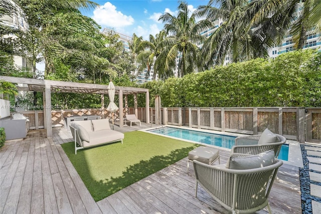 view of swimming pool with a deck, outdoor lounge area, and a pergola