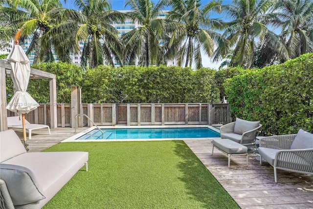 view of pool featuring a lawn and a deck