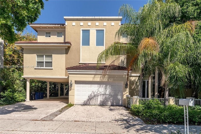 view of front of property featuring a garage and a carport