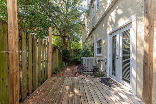 wooden terrace featuring french doors and central air condition unit