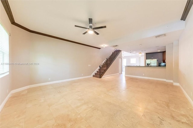 unfurnished living room with ceiling fan and crown molding