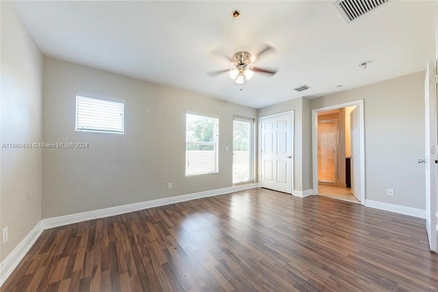 empty room featuring ceiling fan and dark hardwood / wood-style floors