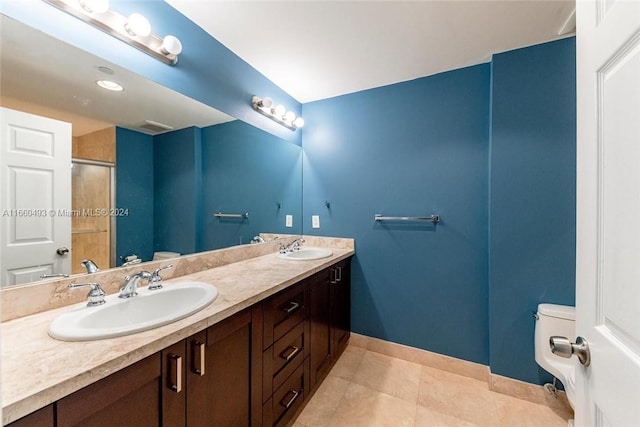 bathroom featuring walk in shower, vanity, toilet, and tile patterned floors