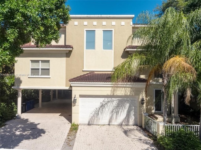 view of front facade featuring a garage and a carport