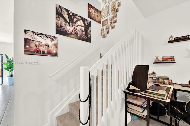 stairway with tile patterned flooring